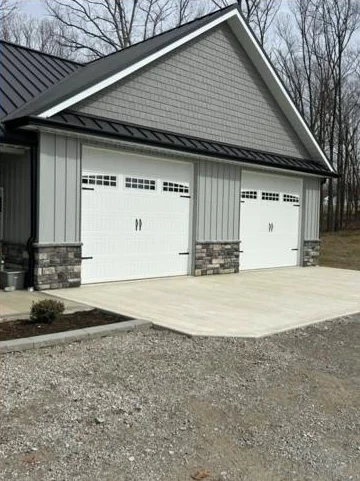 Carriage style garage doors with a standing seam metal roof installed by A&K Metal and Doors in Southern Ohio